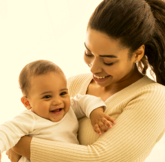 Joyful black mommy carrying baby in arms standing 2023 11 27 05 22 31 utc 1